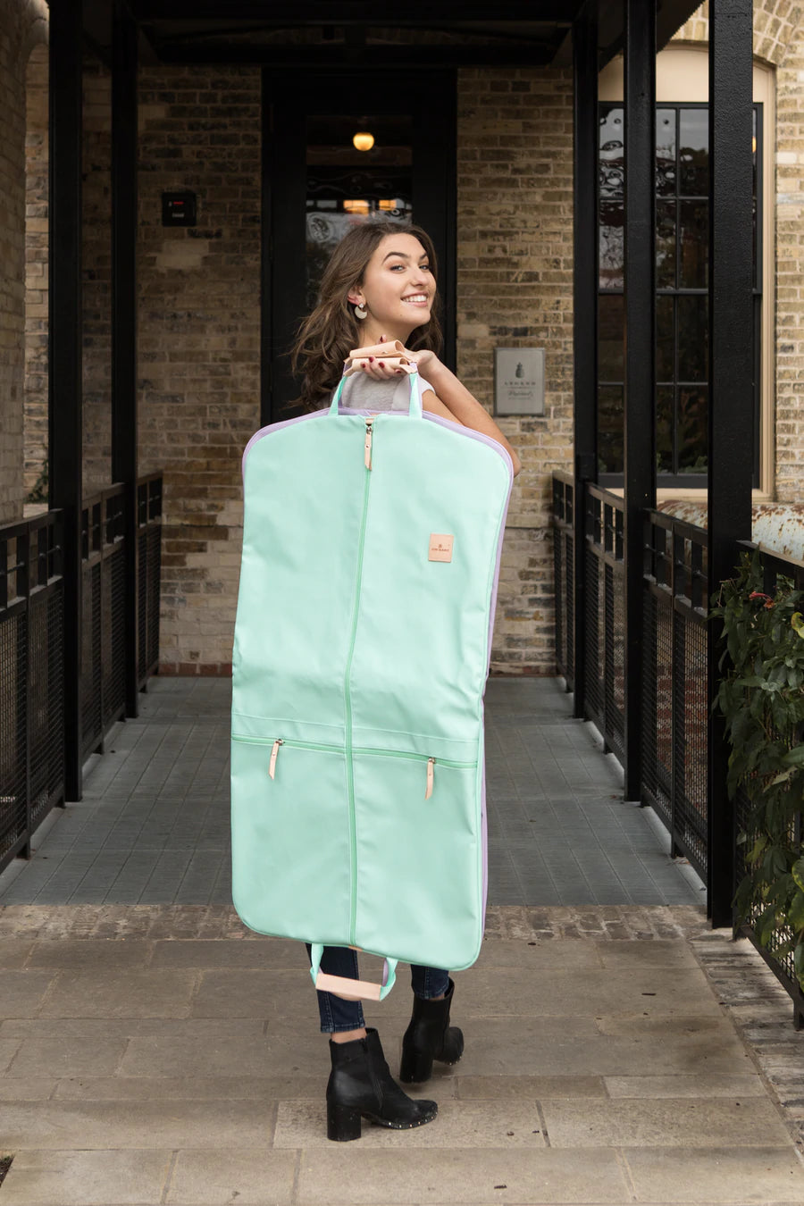 Jon Hart Two Suiter Garment Bag with coated canvas, leather details, and storage for two suits and accessories.