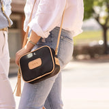 Jon Hart Lola Crossbody, 6.5x9x2.5 in, coated canvas with leather trim and tassel accent.