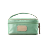 A mint colored Jon Hart mini makeup case with natural leather trim and a leather patch for personalization.