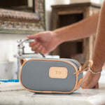 Slate-colored junior shave kit made of coated canvas with natural leather trim, shown from the front with zippered closure and leather carrying straps.