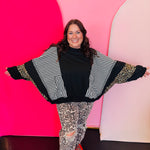 Black top with stripe and leopard contrast panels and dolman sleeves.