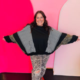 Black top with stripe and leopard contrast panels and dolman sleeves.