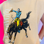 Front view of the Hey Cowgirl Cap Sleeve Tee in wheat color featuring bold cowboy-themed graphics for a trendy Western-inspired look