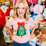 Pink Christmas tee with tree, sparkling red bow, and “Oh Come Let Us Adore Him” script.