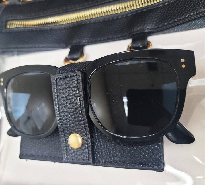 black clear crossbody bag with gold hardware and built-in sunglasses holder—stylish, functional, and stadium-ready.