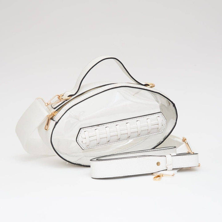 Clear football-shaped crossbody bag with white trim, gold hardware, top handle, and adjustable strap, displayed flat to show structure and detail.