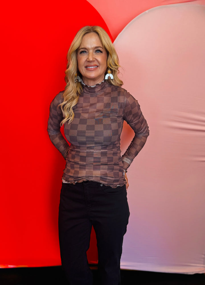 Front view of the Keigan Mesh Top in a chocolate checkered print, featuring a mock neckline, sheer mesh fabric, and lettuce-edge hems—perfect for layering or wearing solo with a tank underneath.