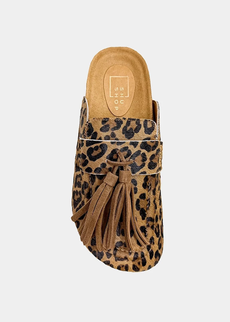ShuShop Ariana leopard print hair-on leather mules with black fringe and buckle detail.