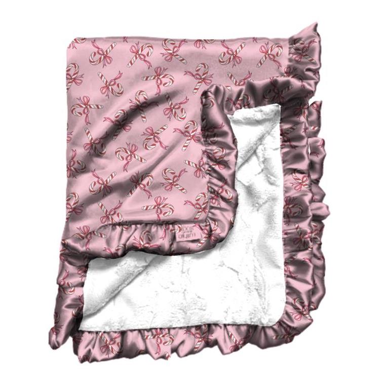 pink satin blanket featuring small red candy canes and bows & trimmed with ruffle 