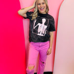Black mineral wash tee with a pink peace sign skeleton graphic.