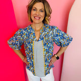 Blue floral top with striped center panel, scalloped trim, V-neckline, and bubble sleeves.