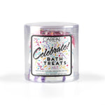 Three cheerful, round bath bombs in light, festive colors with colorful speckles.
