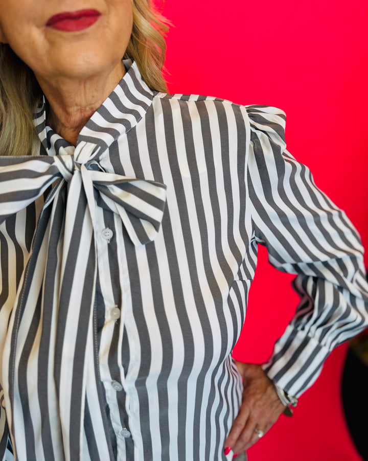 Close up of Charcoal black striped front bow tie blouse.