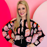 Black tie-front sweater with sparkly beaded dessert motifs and embroidered Queen of Sparkles details.