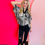 Black and white marbled bandanna print dolman sleeve top with a satin trimmed neckline.