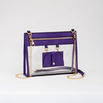 Clear crossbody bag with vibrant purple trim and gold hardware, featuring a detachable sunglasses holder—fun and functional for any event.