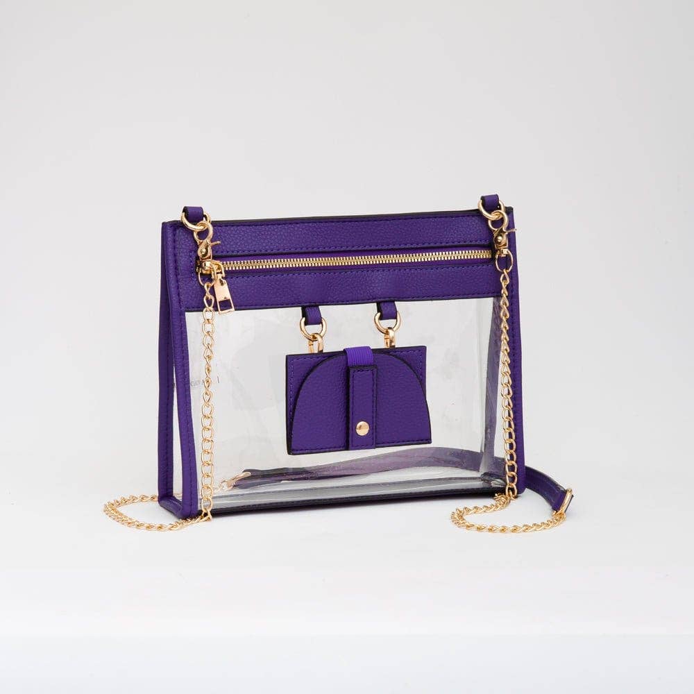 Clear crossbody bag with vibrant purple trim and gold hardware, featuring a detachable sunglasses holder—fun and functional for any event.