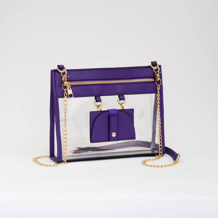 Clear crossbody bag with vibrant purple trim and gold hardware, featuring a detachable sunglasses holder—fun and functional for any event.