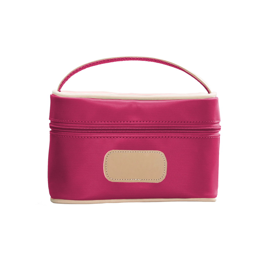 A Berry colored Jon Hart mini makeup case with natural leather trim and a leather patch for personalization.