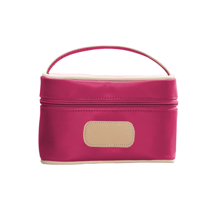 A Berry colored Jon Hart mini makeup case with natural leather trim and a leather patch for personalization.