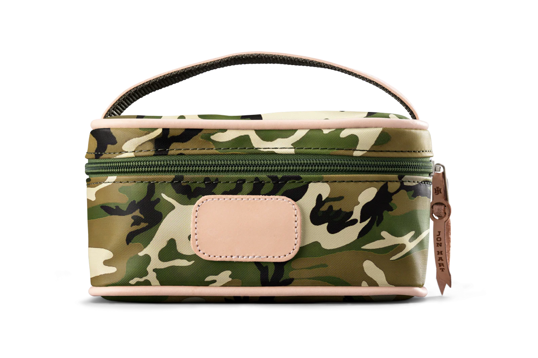 A camo colored Jon Hart mini makeup case with natural leather trim and a leather patch for personalization.