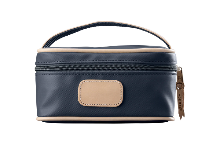 A charcoal colored Jon Hart mini makeup case with natural leather trim and a leather patch for personalization.