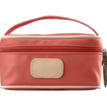 A coral colored Jon Hart mini makeup case with natural leather trim and a leather patch for personalization.
