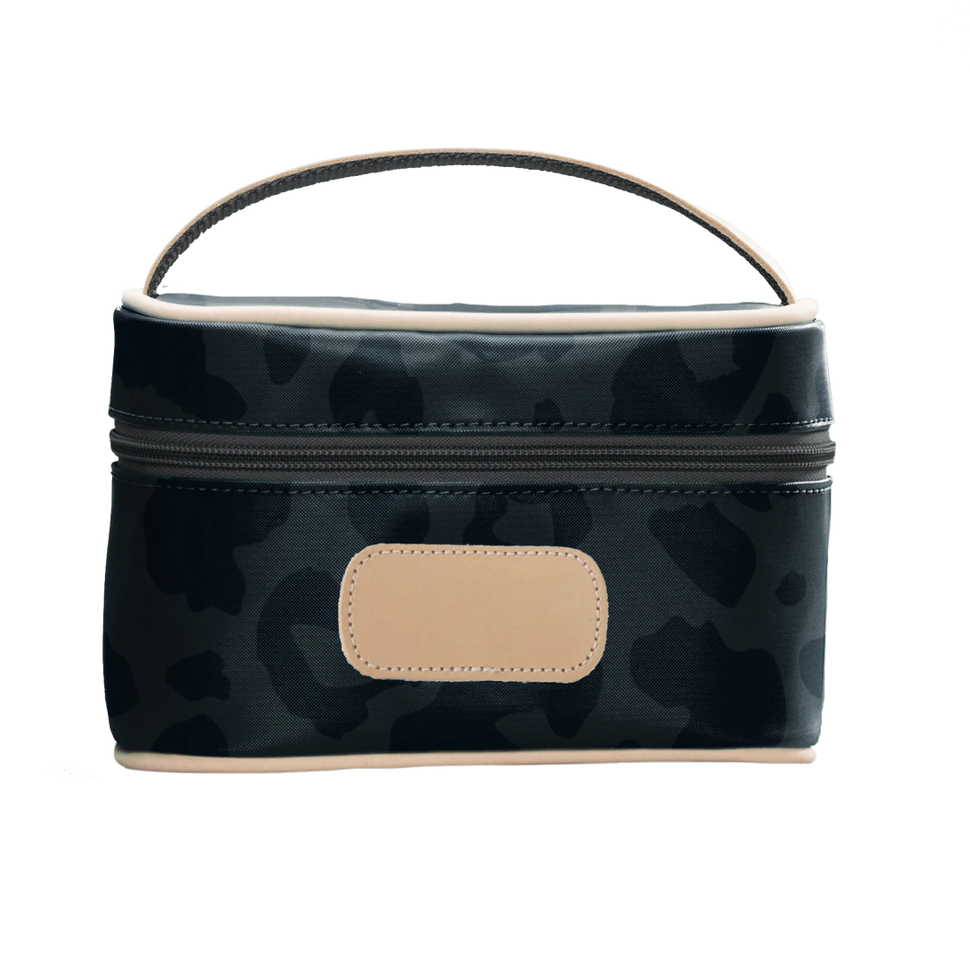 A dark leopard colored Jon Hart mini makeup case with natural leather trim and a leather patch for personalization.