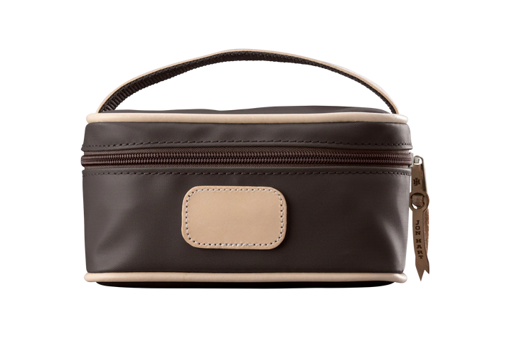 An espresso colored Jon Hart mini makeup case with natural leather trim and a leather patch for personalization.