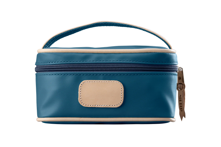 A french blue colored Jon Hart mini makeup case with natural leather trim and a leather patch for personalization.