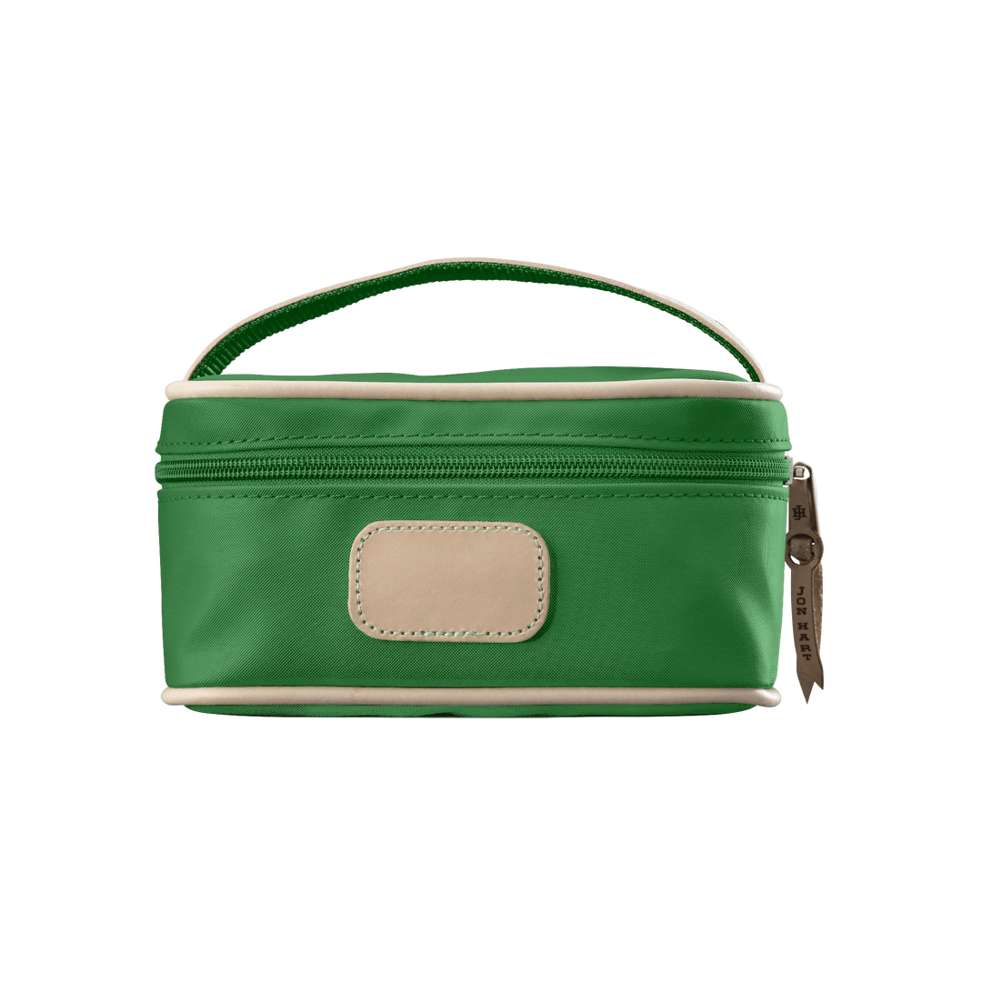 A kelly green colored Jon Hart mini makeup case with natural leather trim and a leather patch for personalization.