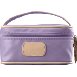 A lilac colored Jon Hart mini makeup case with natural leather trim and a leather patch for personalization.