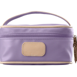 A lilac colored Jon Hart mini makeup case with natural leather trim and a leather patch for personalization.