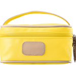 A lemon yellow colored Jon Hart mini makeup case with natural leather trim and a leather patch for personalization.