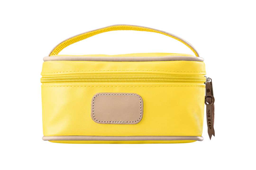 A lemon yellow colored Jon Hart mini makeup case with natural leather trim and a leather patch for personalization.