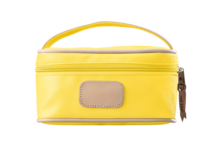 A lemon yellow colored Jon Hart mini makeup case with natural leather trim and a leather patch for personalization.