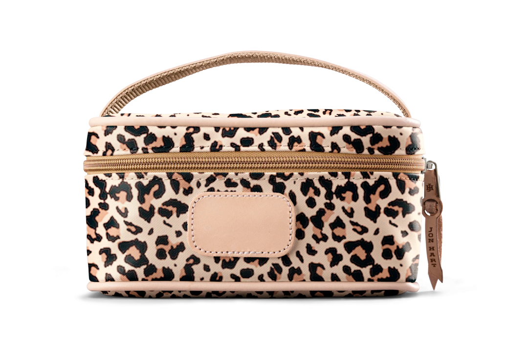 A leopard colored Jon Hart mini makeup case with natural leather trim and a leather patch for personalization.