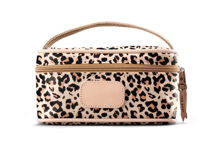 A leopard colored Jon Hart mini makeup case with natural leather trim and a leather patch for personalization.