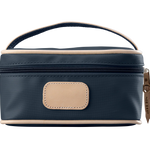 A navy colored Jon Hart mini makeup case with natural leather trim and a leather patch for personalization.