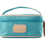 An ocean blue colored Jon Hart mini makeup case with natural leather trim and a leather patch for personalization.