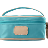 An ocean blue colored Jon Hart mini makeup case with natural leather trim and a leather patch for personalization.