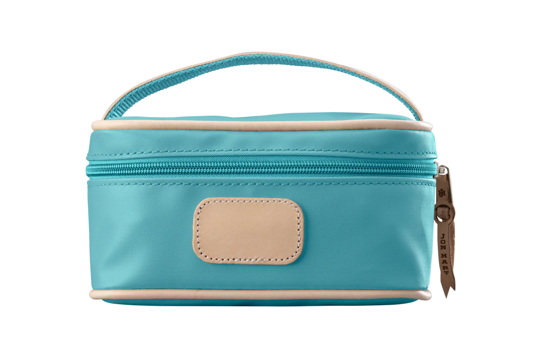An ocean blue colored Jon Hart mini makeup case with natural leather trim and a leather patch for personalization.