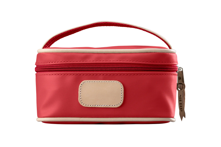 A red colored Jon Hart mini makeup case with natural leather trim and a leather patch for personalization.
