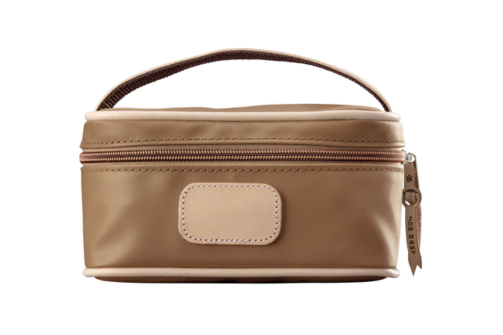 A saddle colored Jon Hart mini makeup case with natural leather trim and a leather patch for personalization.