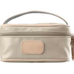 A tan colored Jon Hart mini makeup case with natural leather trim and a leather patch for personalization.