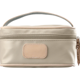 A tan colored Jon Hart mini makeup case with natural leather trim and a leather patch for personalization.