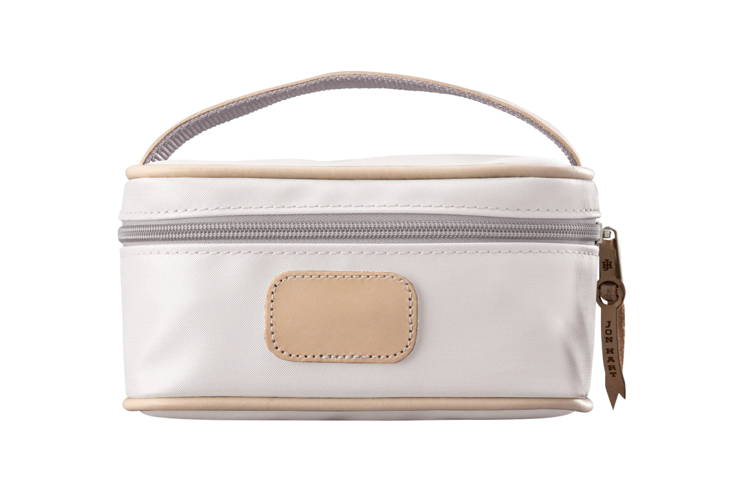 A white colored Jon Hart mini makeup case with natural leather trim and a leather patch for personalization.