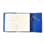 Calendar view of blue clutch journal folio and calendar with 'BAD BITCH ENERGY' text and colored pen.