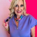 Model posing with the Lavender Fog cat-eye polarized sunglasses, highlighting the bold design and fashion-forward mid-fit style.