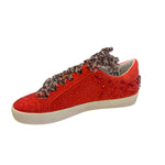 Inner side of red embellished sneaker with clean vegan leather finish and rhinestone embellishments.
